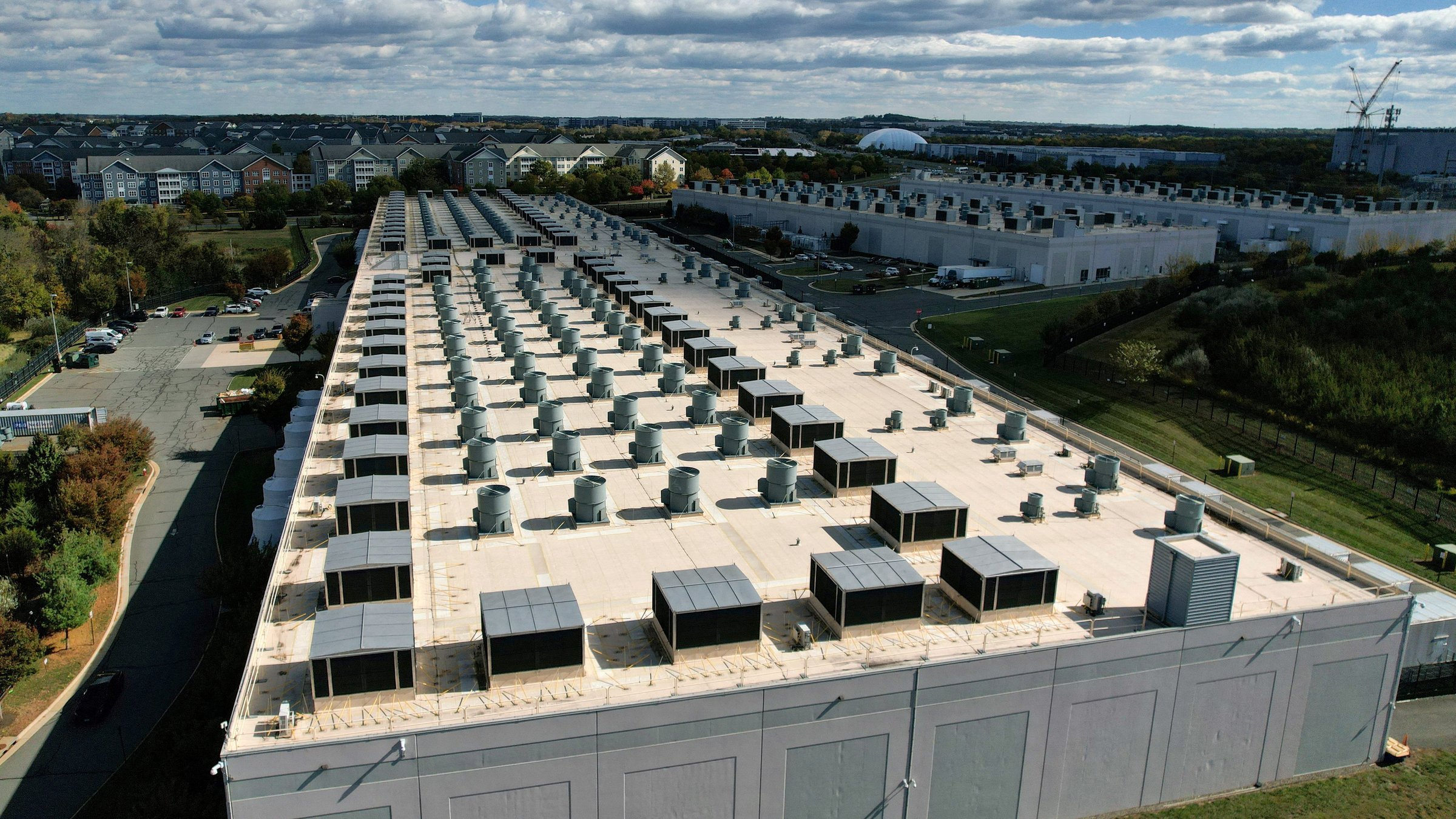 Engineer walking through server racks in a hyperscale data center